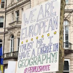 Placard: Trust me, I have a degree in geography