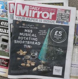 Daily Mirror cover covered by wraparound ad
