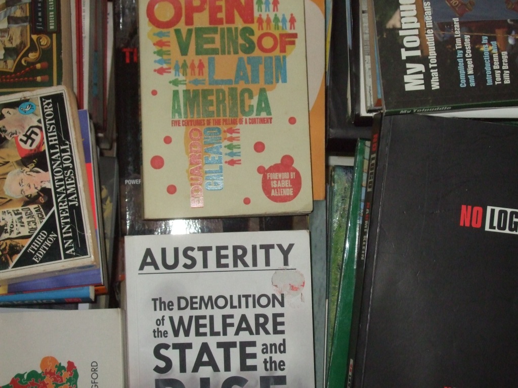 Pile of political books, with 'the Open Veins of Latin America' on top