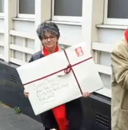 Julia delivers a LARGE letter at the demonstration after the public meeting to save the post office.