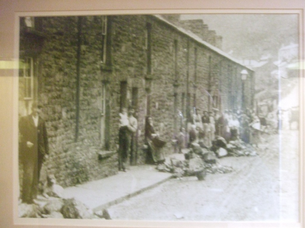 Row of miners' houses, with piles of uncut coal in the street by each door
