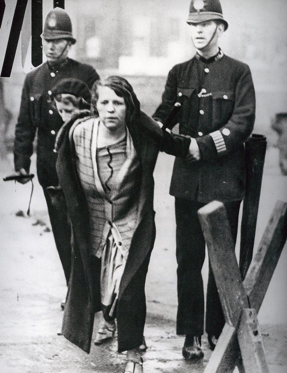 Police twisting a woman's arm