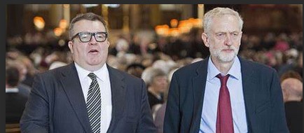 Tom Watson sticking his chest out alongside a rather bemused looking Corbyn