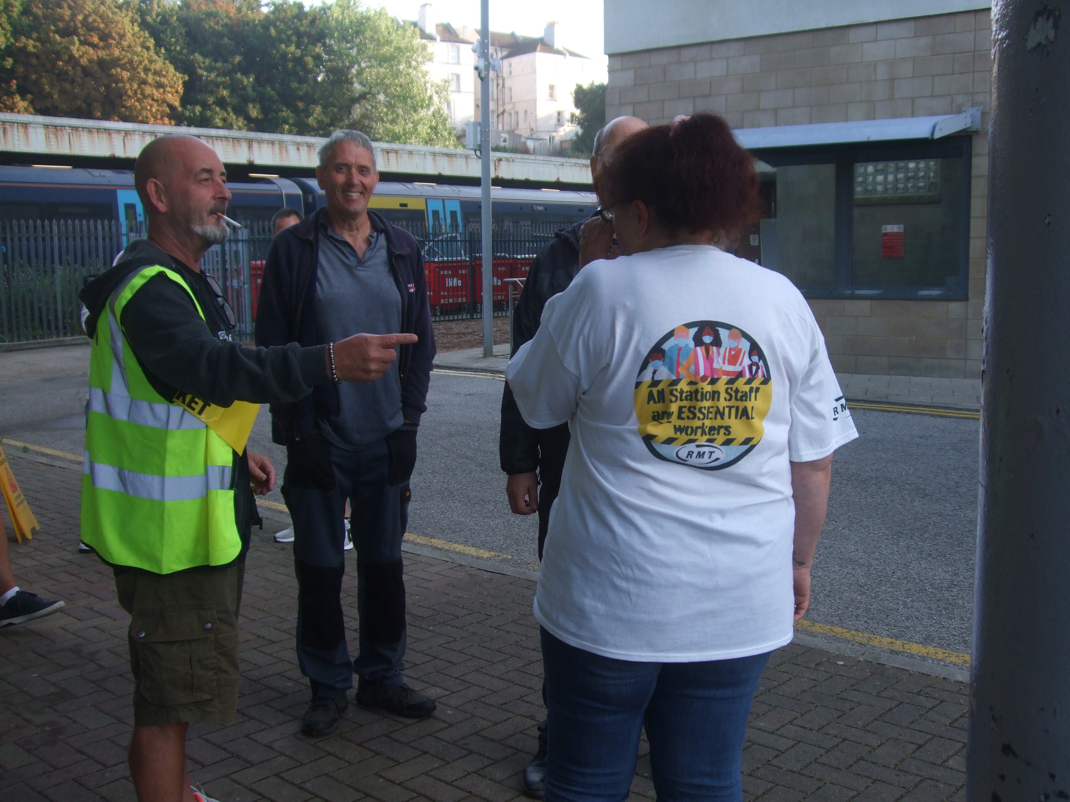 ticket office staff wearing ESSENTIAL WORKERS teeshirts