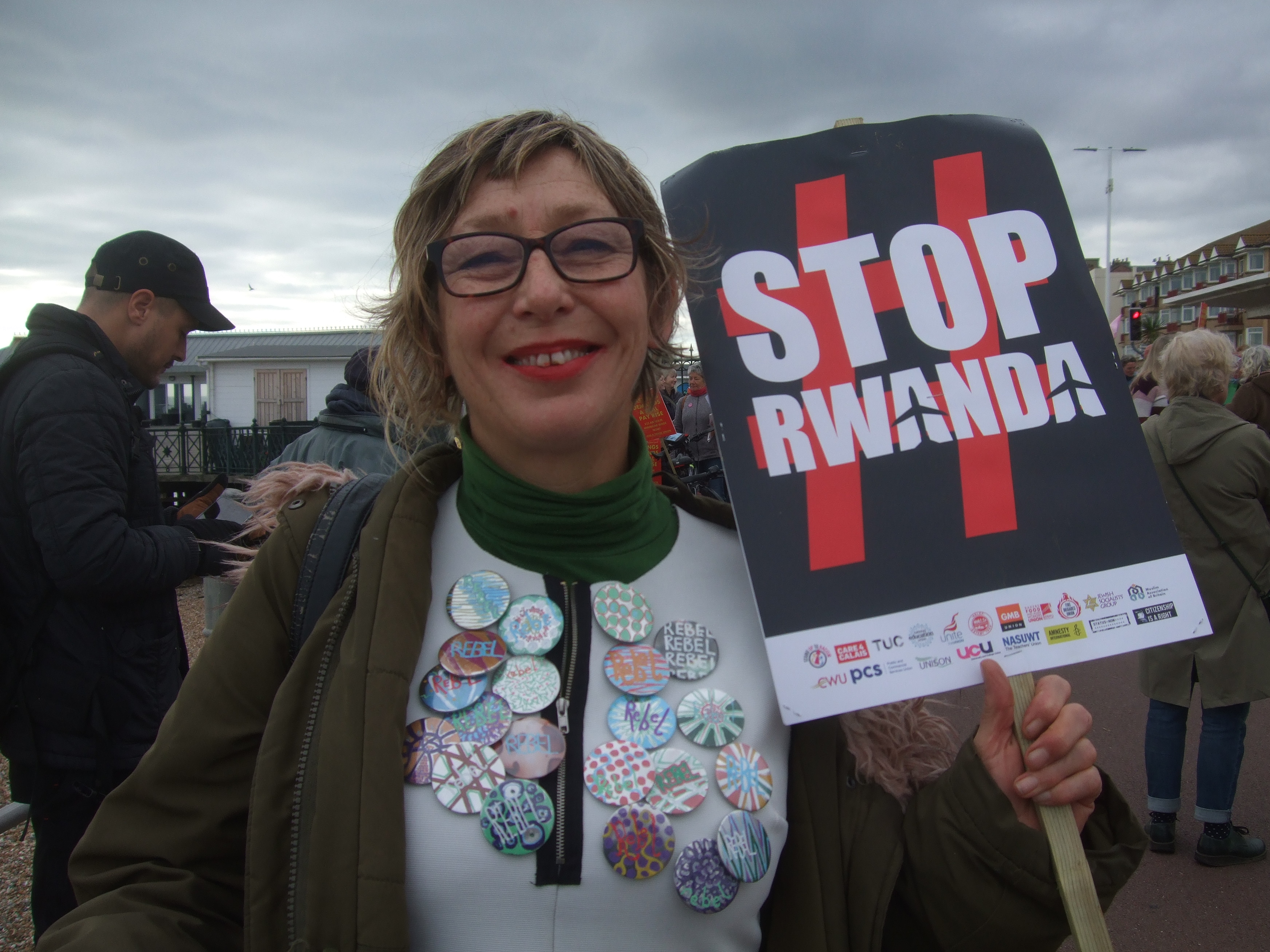 Stop Rwanda placard, rebel badges