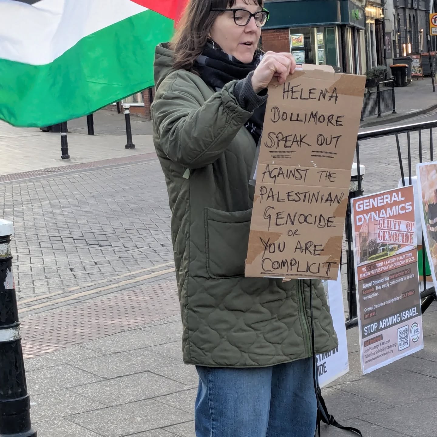 Placard reads: Helena Dollimore SPEAK OUT against Palestinian genocide or you are COMPLICIT