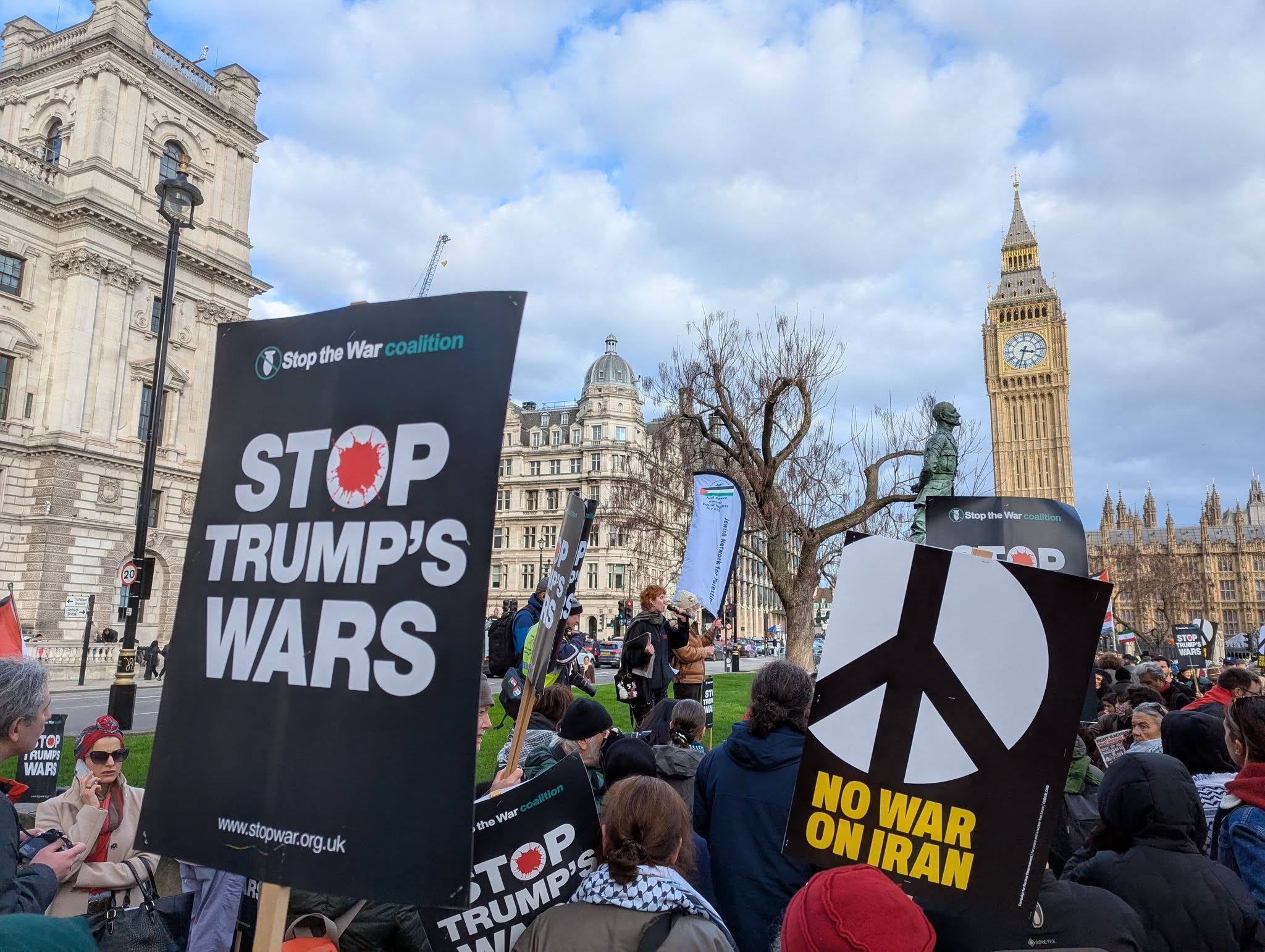 Placards in Parliament Square - 'stop Trump's wars' and 'no war on Iran'