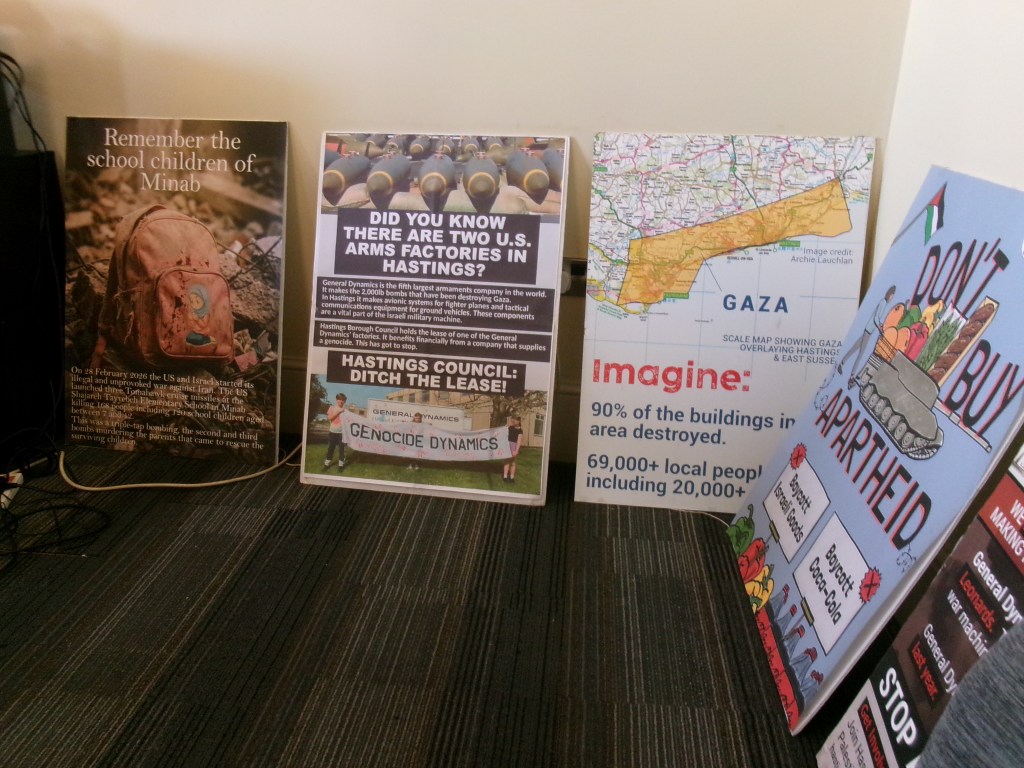 Info boards round the walls at PSC meeting Remember Minab, Genocide dynamics, don't buy apartheid....